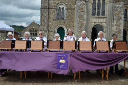 Dunkeswell Handbell Ringers performing outside St Paul's Church on Honiton Market Charter Day 2025
