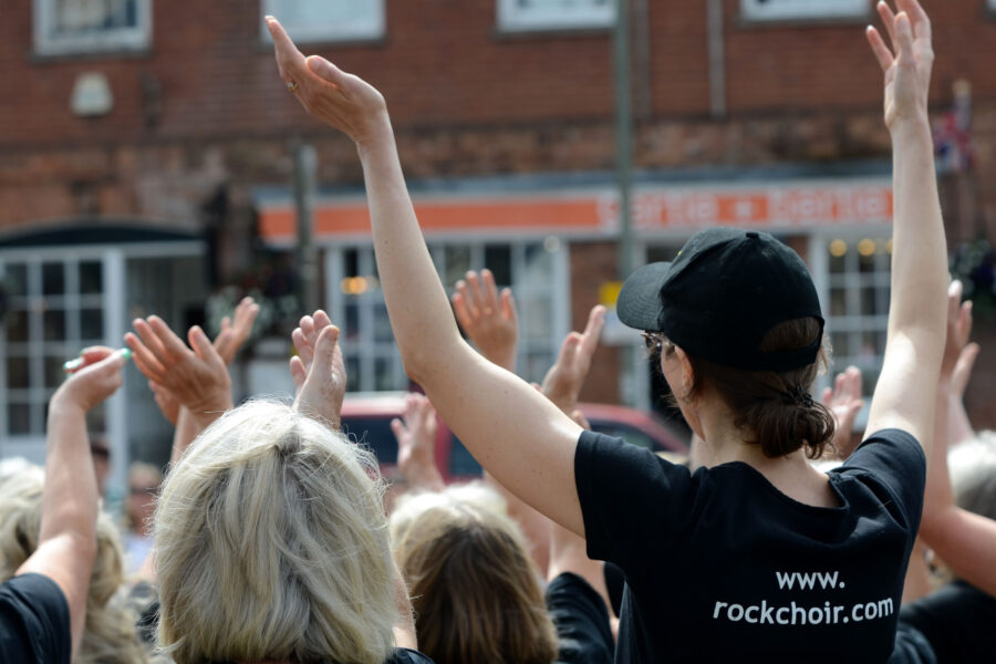 The Rock Choir performing outside St Paul's Church on Honiton Market Charter Day 2025
